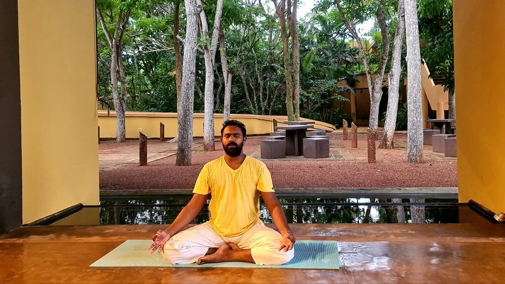 Amesh seated in cross legged Yoga asana